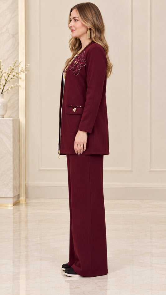 Side view of women's burgundy longline zip jacket and matching wide-leg trousers