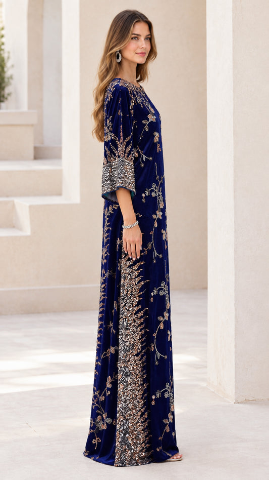 Side profile of woman wearing navy blue beaded velvet evening gown