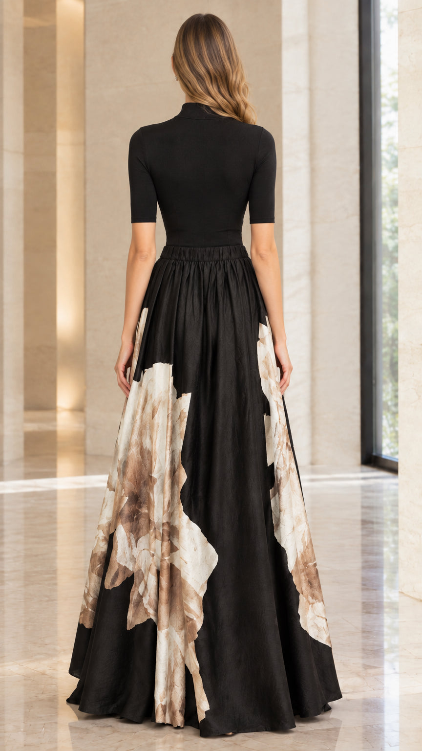 Back view of model in black high neck pleated floral maxi gown