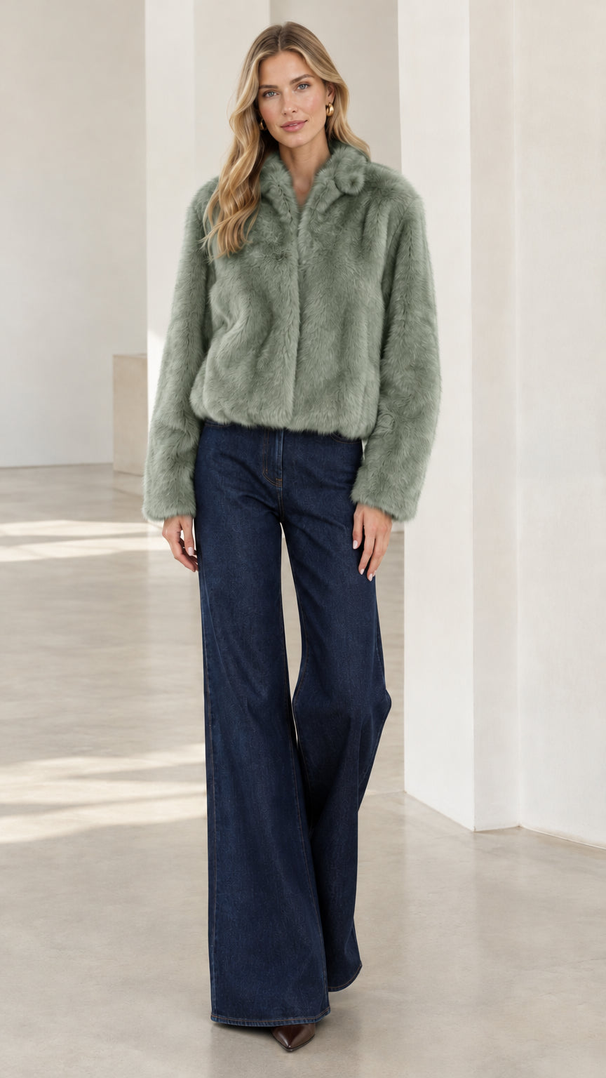 Model wearing sage green cropped faux fur jacket with flare trousers