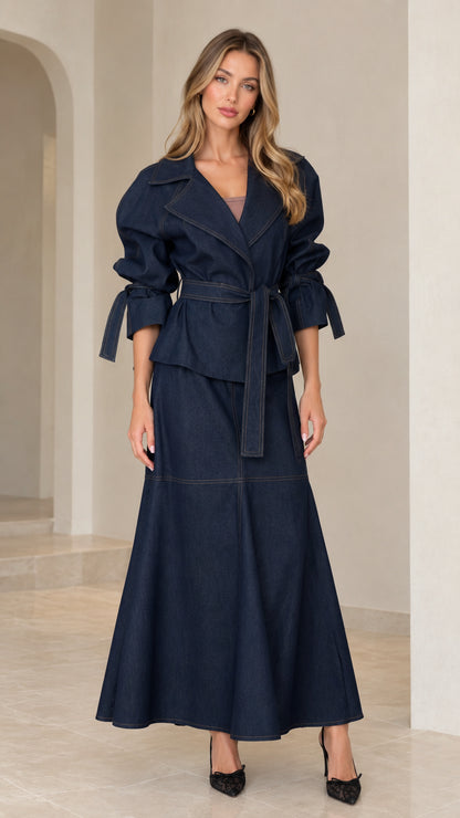 Front full view of woman wearing dark navy blue belted lapel jacket and matching A-line maxi skirt set