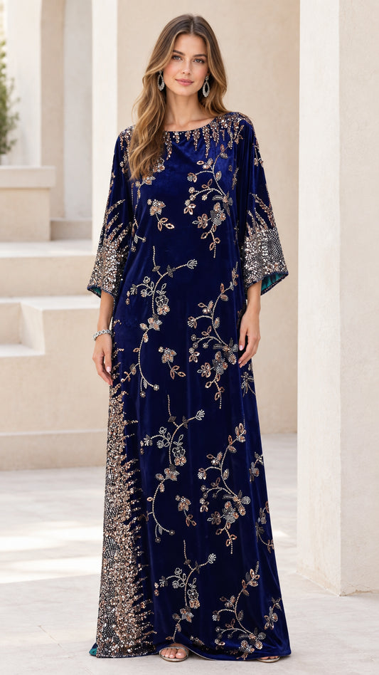 Front full-length view of woman wearing navy blue embellished velvet kaftan maxi dress