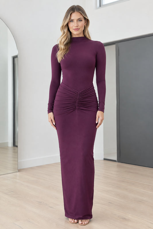 Full front view of model wearing Plum mock neck long sleeve ruched maxi dress