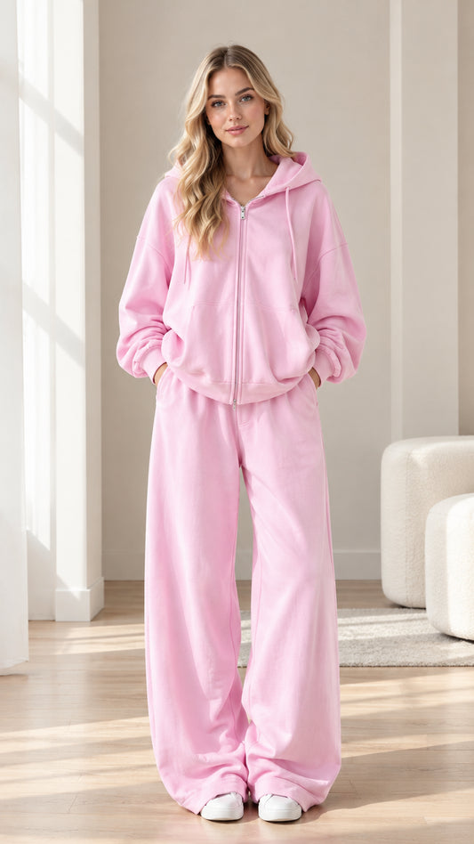 Front full-length view of woman wearing pink zip-up hoodie and wide-leg sweatpants set
