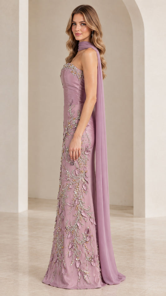 Side profile view of mauve embellished strapless formal dress with flowing back capelet