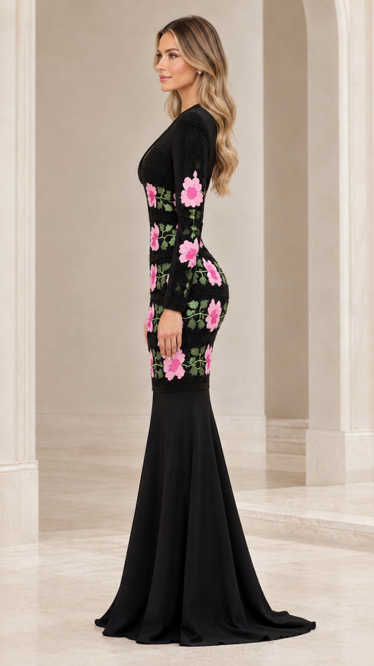 Side profile of black long sleeve mermaid gown showing flared train and hip floral embroidery