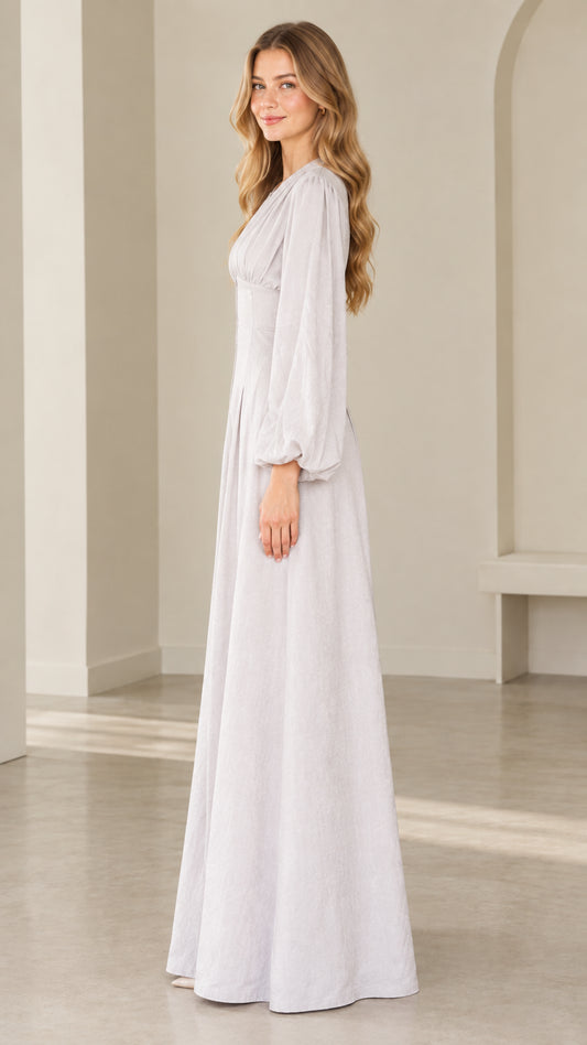 Side profile view of dove grey long sleeve wide leg formal jumpsuit