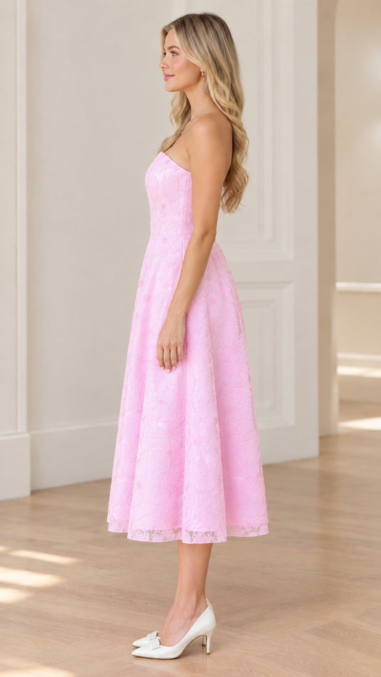 Side profile of woman in strapless pink floral lace midi dress