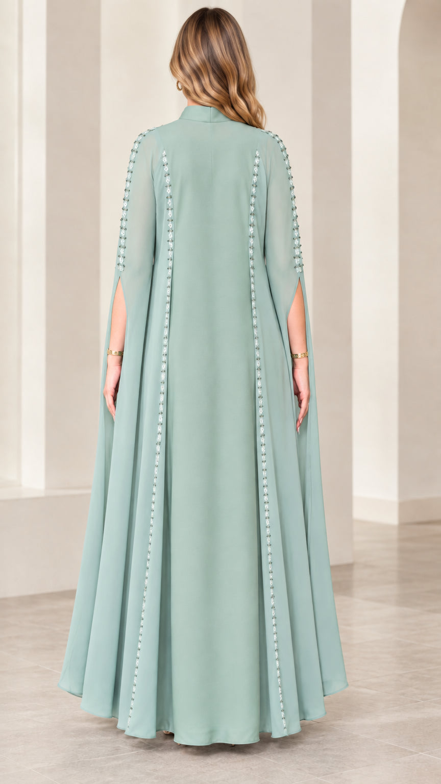 Back view of sage green maxi dress highlighting sweeping cape overlay