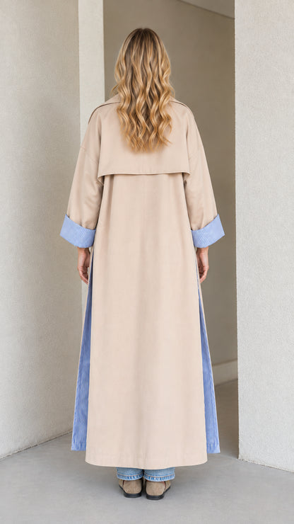 Back view of beige full-length trench coat with storm flap and split hem