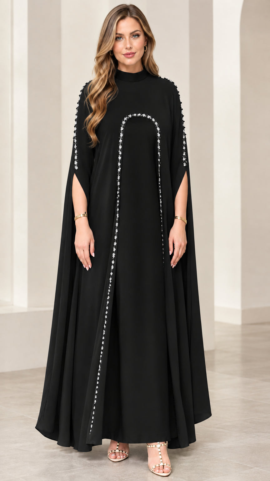 Full front view of black mock neck cape sleeve maxi dress with pearl embellishments