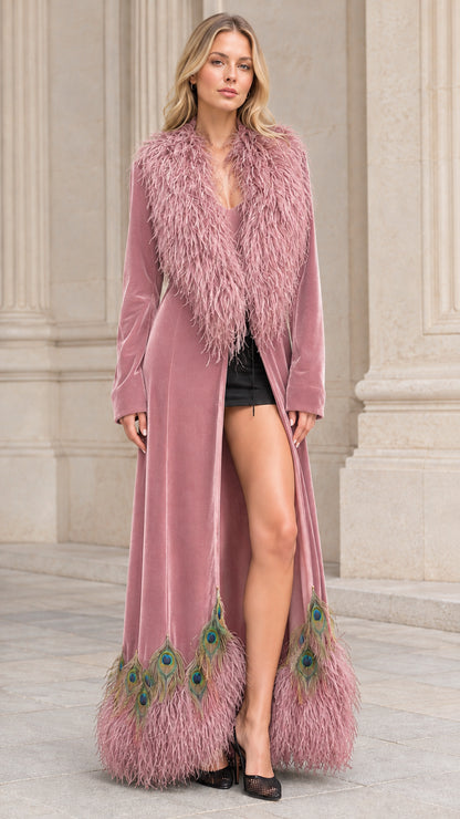 Model wearing dusty pink velvet maxi coat with matching feather trim