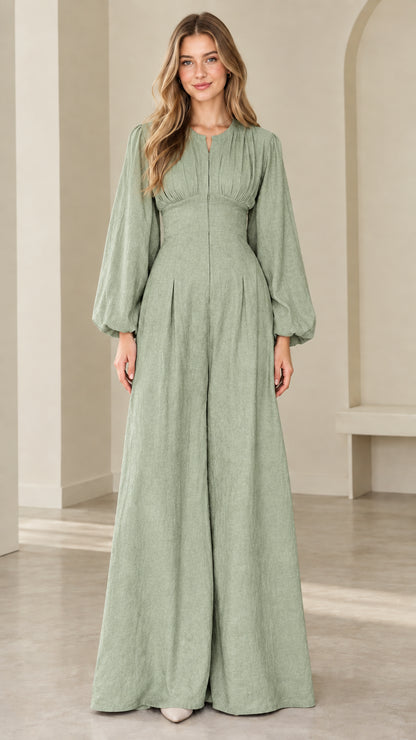 Model wearing sage green wide leg pleated jumpsuit