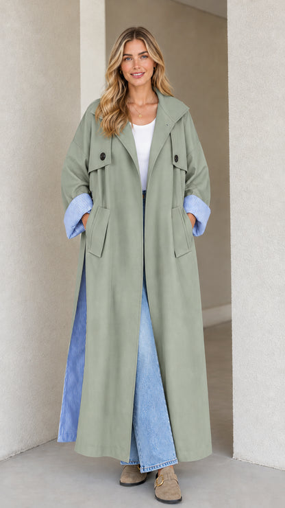 Front view of sage green maxi trench coat with striped cuff detail